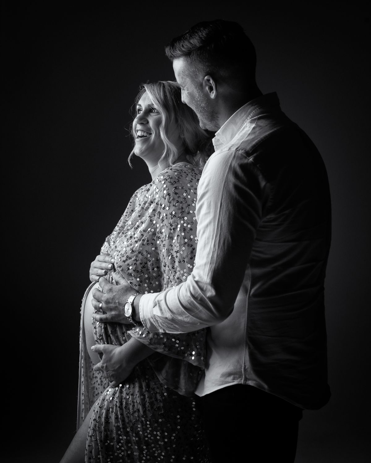 Black and white maternity photo of couple expecting baby