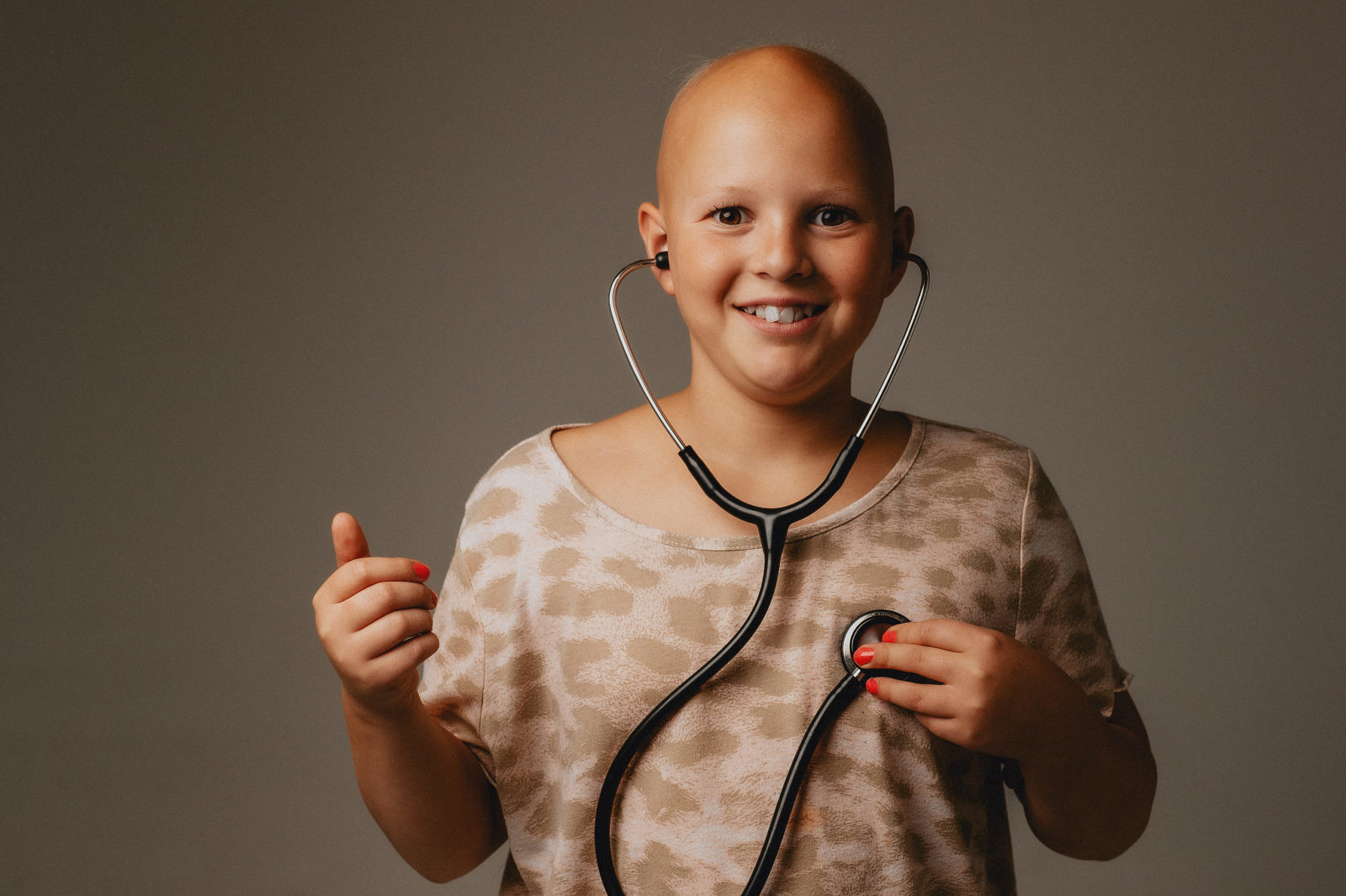 Girl with bald head and stethoscope